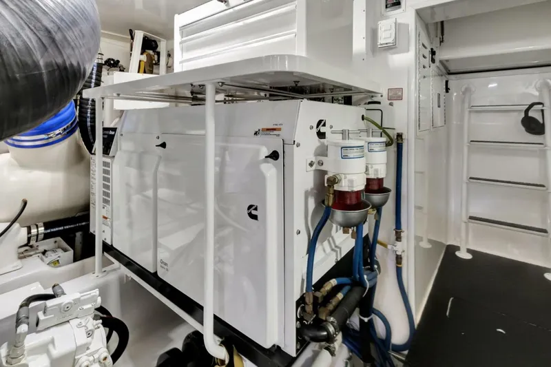 Desparado Yacht Photos Pics Engine room of 2019 Viking 68 Convertible yacht, featuring Cummins generator and fuel filters.