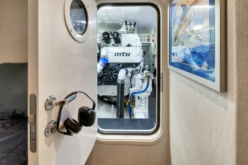 Desparado Yacht Photos Pics Engine room of 2019 Viking 68 Convertible yacht with MTU engine visible through open door.