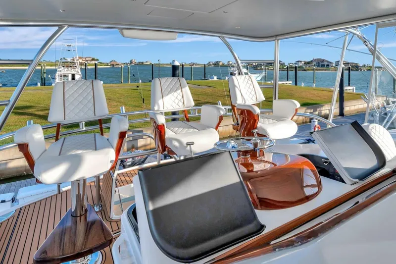 Desparado Yacht Photos Pics Luxurious interior of 2019 Viking 68 Convertible yacht with elegant seating and scenic waterfront view.