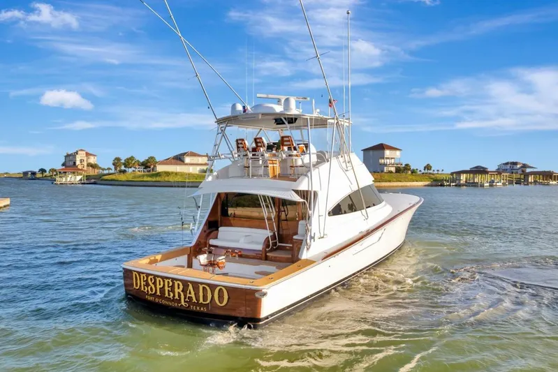 Desparado Yacht Photos Pics 2019 Viking 68 Convertible yacht "Desperado" cruising in scenic waters near coastal homes.
