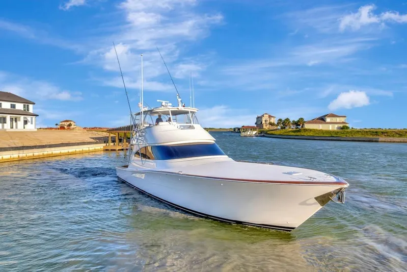 Desparado Yacht Photos Pics 2019 Viking 68 Convertible yacht cruising in a scenic waterfront setting.