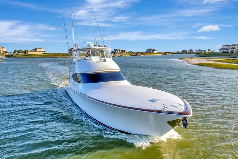 Desparado Yacht Photos Pics 2019 Viking 68 Convertible yacht cruising in a scenic coastal waterway.