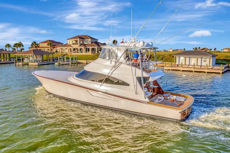 Desparado Yacht Photos Pics 2019 Viking 68 Convertible yacht cruising near luxury waterfront homes.