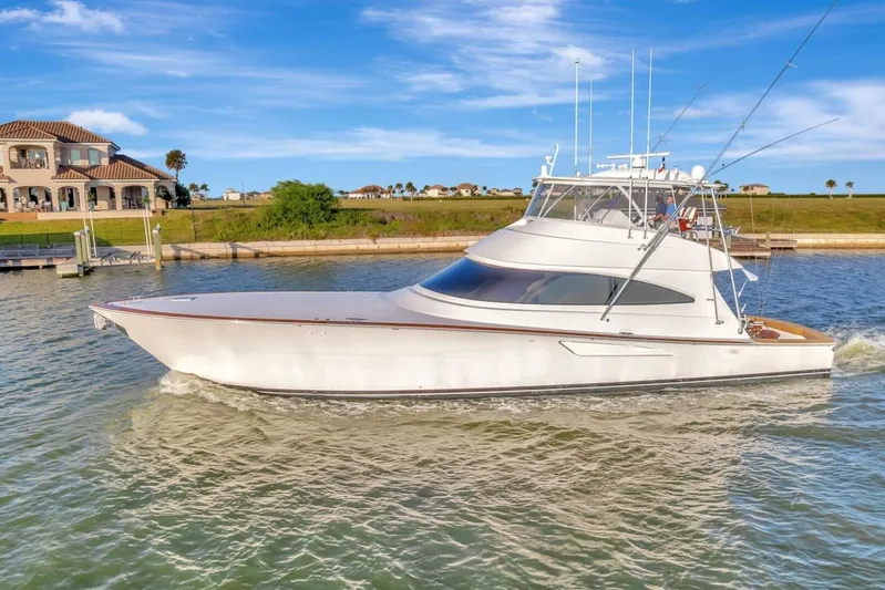 Desparado Yacht Photos Pics 2019 Viking 68 Convertible yacht cruising on a sunny day near waterfront homes.