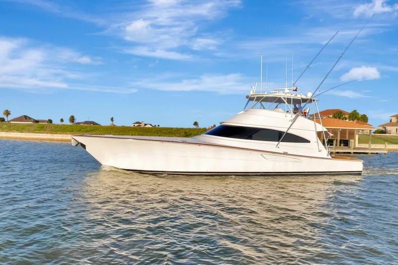 Desparado Yacht Photos Pics 2019 Viking 68 Convertible yacht cruising on a sunny day, with clear blue skies.