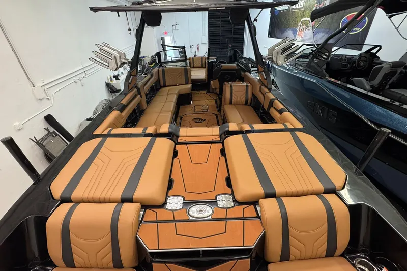  Yacht Photos Pics 2026 Malibu Wakesetter 25 LSV interior with luxurious tan and black seating.