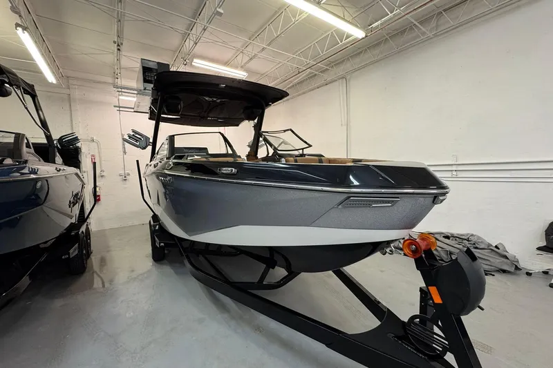  Yacht Photos Pics 2026 Malibu Wakesetter 25 LSV boat in a showroom, sleek design and modern features.