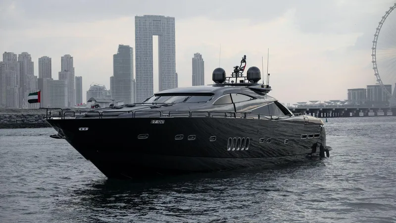  Yacht Photos Pics 2004 Sunseeker Predator 95 yacht cruising near city skyline and Ferris wheel.