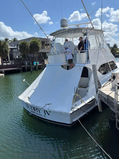 Audrey IV Yacht Photos Pics 2002 Hatteras 50 Convertible yacht docked in a sunny marina setting.