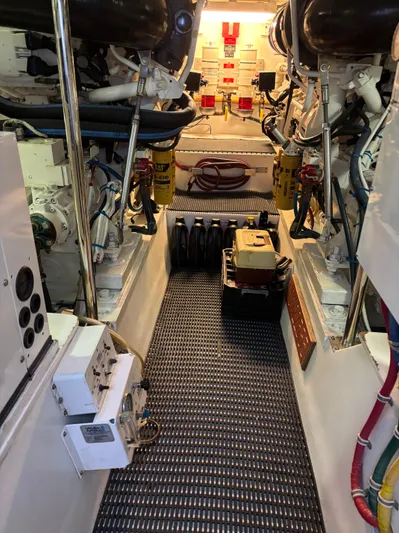 Audrey IV Yacht Photos Pics Engine room of 2002 Hatteras 50 Convertible yacht, showcasing machinery and equipment.