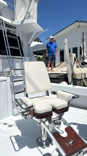 Audrey IV Yacht Photos Pics 2002 Hatteras 50 Convertible yacht with fishing chair, docked under clear blue sky.