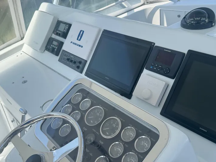 Audrey IV Yacht Photos Pics Control panel of a 2002 Hatteras 50 Convertible yacht with navigation instruments.