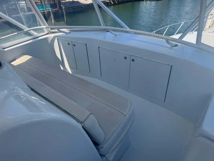 Audrey IV Yacht Photos Pics 2002 Hatteras 50 Convertible yacht interior with cushioned seating and storage cabinets.