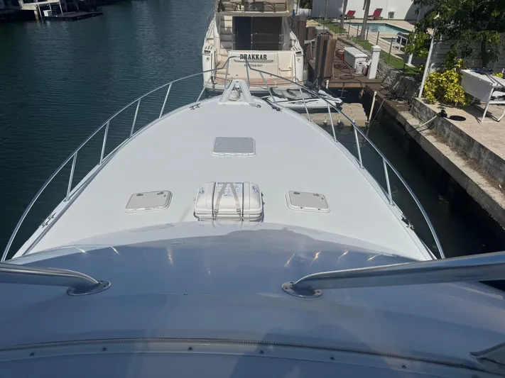 Audrey IV Yacht Photos Pics Bow view of 2002 Hatteras 50 Convertible yacht docked in marina.
