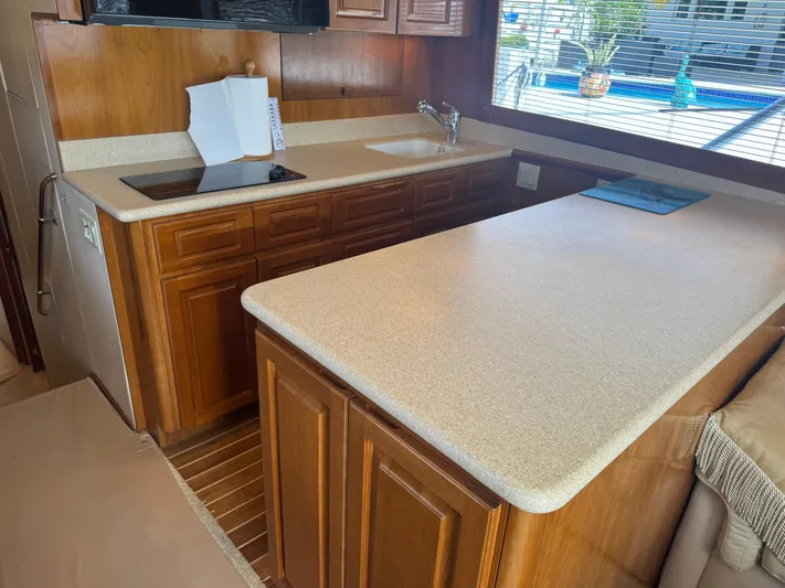 Audrey IV Yacht Photos Pics Interior of 2002 Hatteras 50 Convertible yacht with wooden cabinetry and countertop.