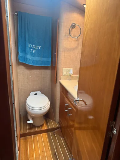 Audrey IV Yacht Photos Pics Bathroom interior of 2002 Hatteras 50 Convertible yacht with wooden finishes.