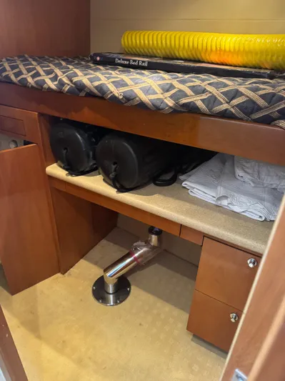 Audrey IV Yacht Photos Pics Interior storage area of 2002 Hatteras 50 Convertible yacht with equipment and bedding.