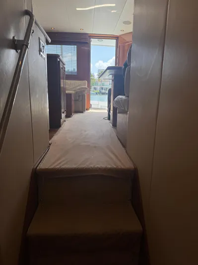 Audrey IV Yacht Photos Pics Interior view of 2002 Hatteras 50 Convertible yacht, showing stairs and seating area.