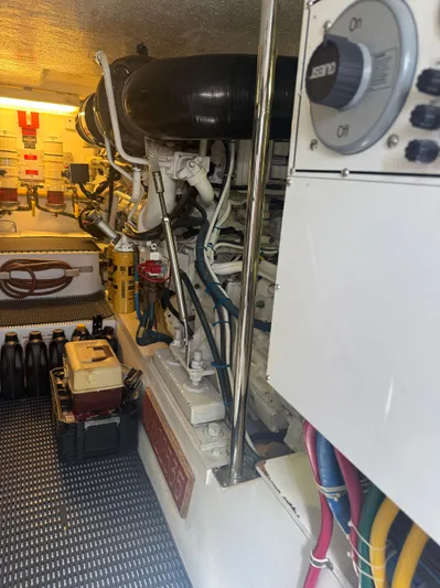 Audrey IV Yacht Photos Pics Engine room of 2002 Hatteras 50 Convertible yacht, showcasing equipment and wiring.