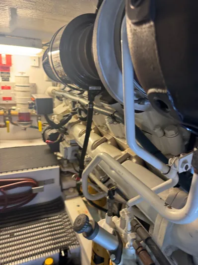 Audrey IV Yacht Photos Pics Engine room of a 2002 Hatteras 50 Convertible yacht, showcasing mechanical components.