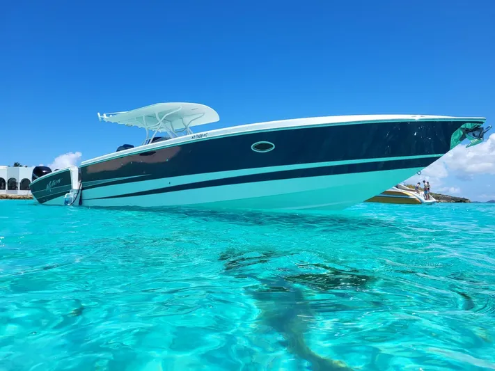  Yacht Photos Pics 2011 Motion Marine 42 boat on clear turquoise water under blue sky.