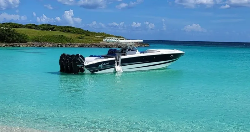  Yacht Photos Pics 2011 Motion Marine 42 boat in clear turquoise water near a lush coastline.