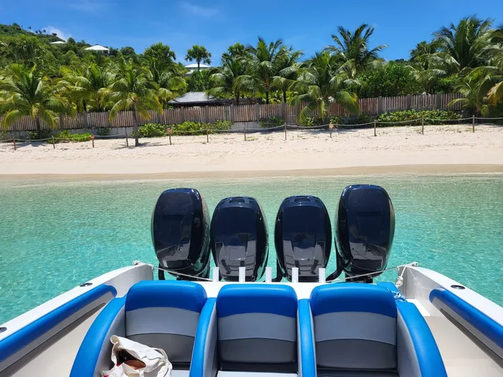  Yacht Photos Pics 2011 Motion Marine 42 boat with four engines near a tropical beach.