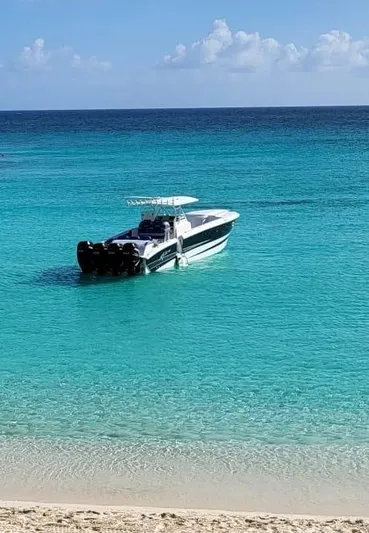  Yacht Photos Pics 2011 Motion Marine 42 boat on turquoise ocean near sandy beach.