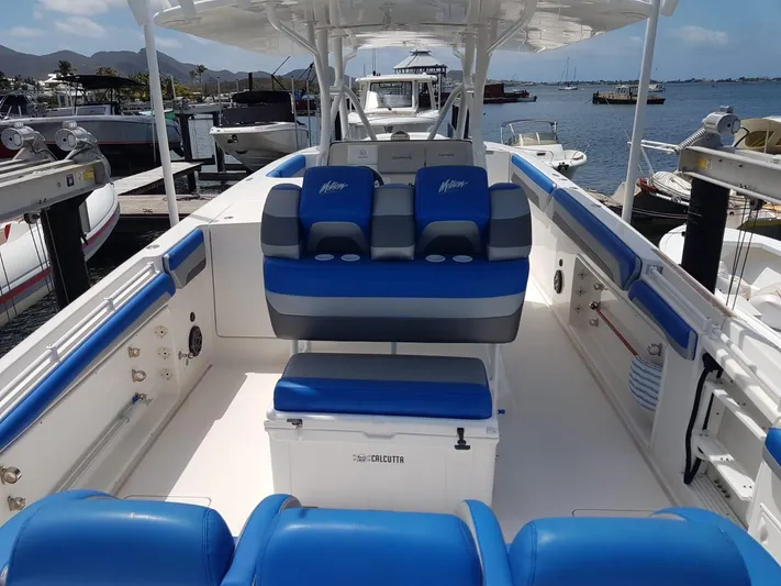  Yacht Photos Pics 2011 Motion Marine 42 boat with blue seating, docked at a marina.