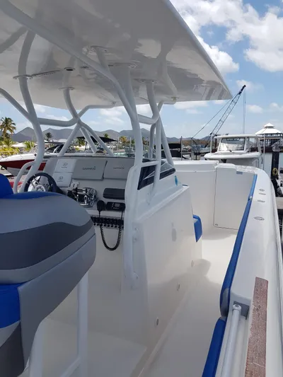 Yacht Photos Pics 2011 Motion Marine 42 boat with sleek design, docked under a clear blue sky.