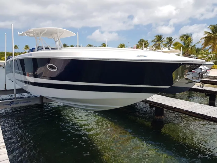  Yacht Photos Pics 2011 Motion Marine 42 boat docked, sleek design, blue and white hull, tropical setting.