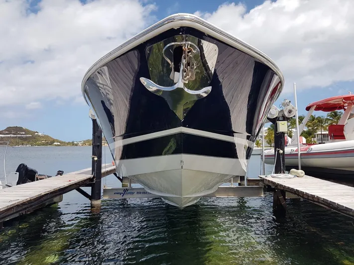  Yacht Photos Pics 2011 Motion Marine 42 boat docked, viewed from the front, with clear skies and calm water.