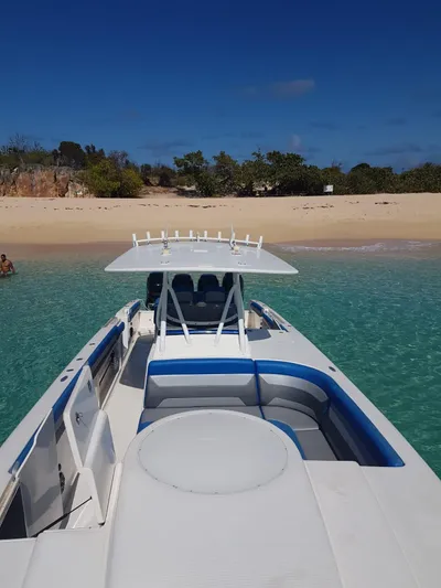 Yacht Photos Pics 2011 Motion Marine 42 boat anchored near a sandy beach with clear blue water.