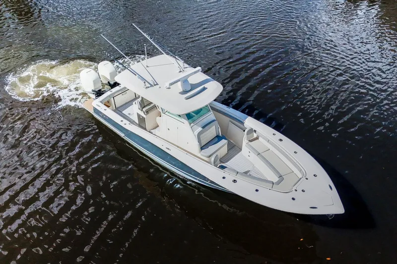  Yacht Photos Pics 2019 Scout 320 LXF boat cruising on calm water, aerial view.