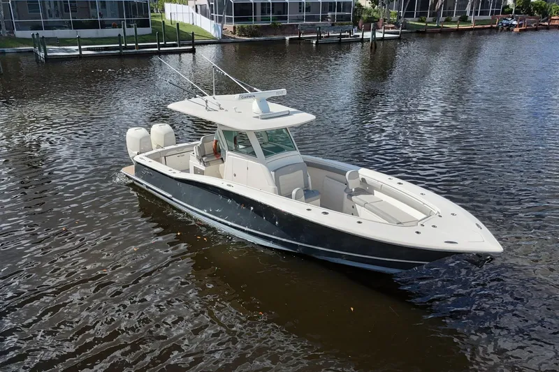  Yacht Photos Pics 2019 Scout 320 LXF boat on calm water, featuring sleek design and dual engines.