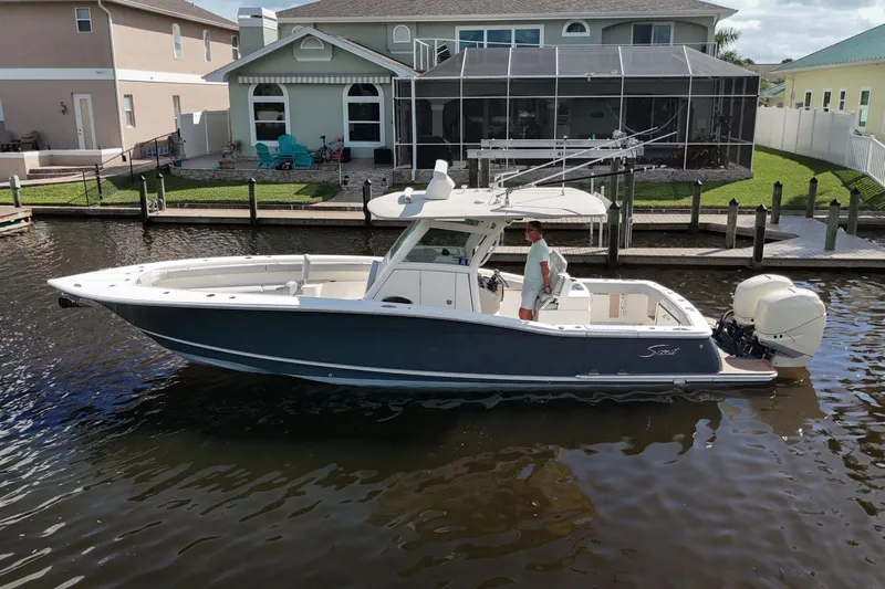  Yacht Photos Pics 2019 Scout 320 LXF boat docked near waterfront homes.