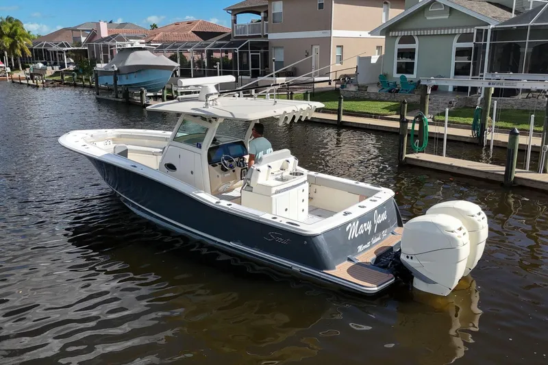  Yacht Photos Pics 2019 Scout 320 LXF boat cruising in a residential canal.