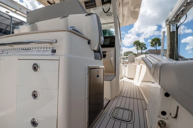  Yacht Photos Pics 2019 Scout 320 LXF boat interior with seating, storage, and sleek design under a blue sky.