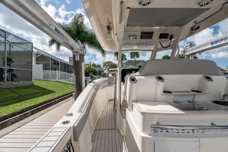  Yacht Photos Pics 2019 Scout 320 LXF boat docked, showcasing sleek interior and modern amenities.