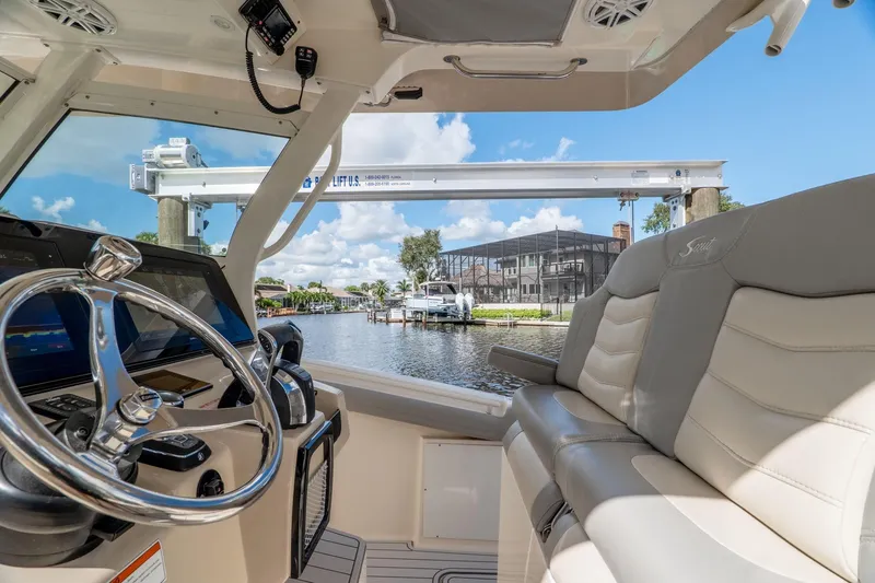  Yacht Photos Pics 2019 Scout 320 LXF boat interior with steering wheel and luxurious seating.