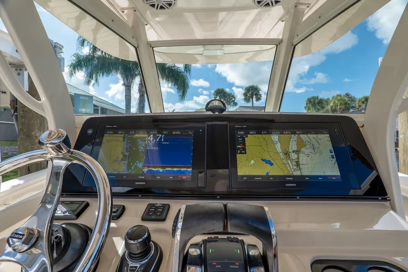  Yacht Photos Pics 2019 Scout 320 LXF boat dashboard with navigation screens and steering wheel.