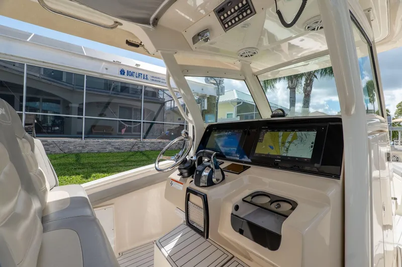  Yacht Photos Pics 2019 Scout 320 LXF boat cockpit with modern navigation system and comfortable seating.