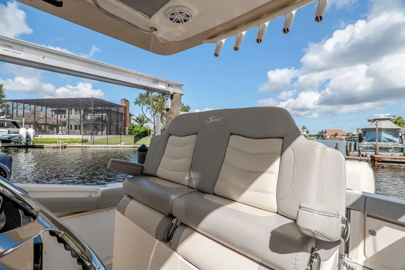  Yacht Photos Pics 2019 Scout 320 LXF boat interior with luxurious seating, dockside view, and clear blue sky.