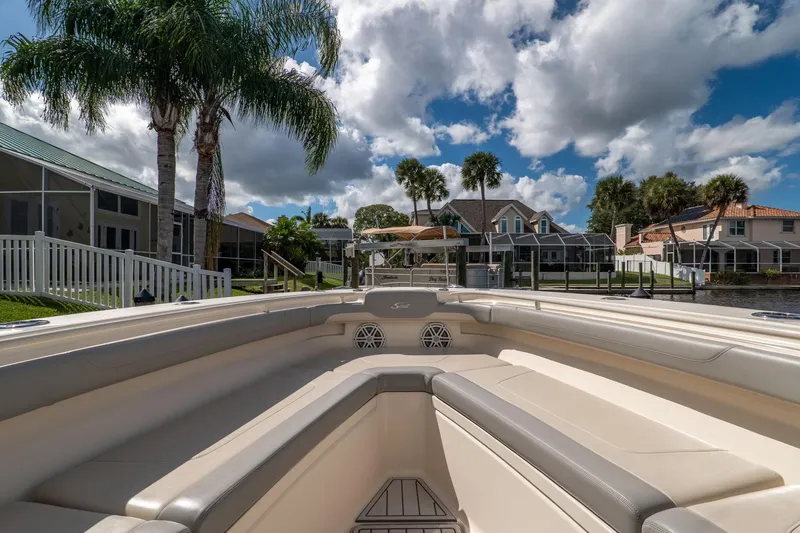  Yacht Photos Pics 2019 Scout 320 LXF boat interior with palm trees and waterfront homes in the background.