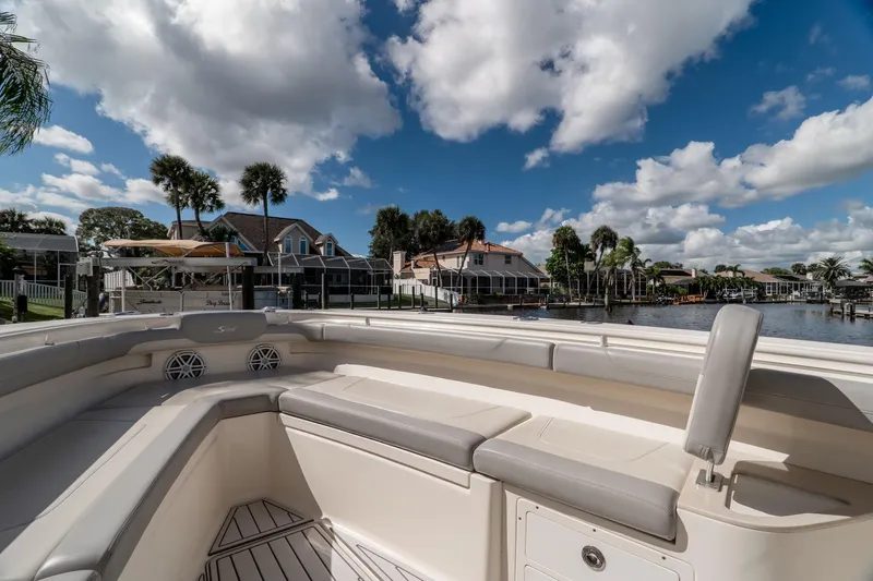  Yacht Photos Pics 2019 Scout 320 LXF boat interior with waterfront view, under a partly cloudy sky.