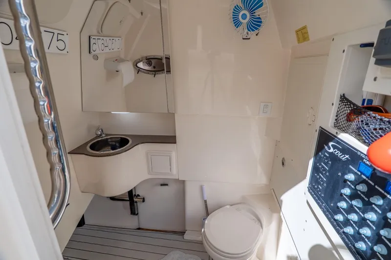  Yacht Photos Pics 2019 Scout 320 LXF boat interior with sink, toilet, and control panel.