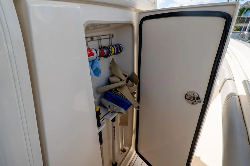 Yacht Photos Pics Storage compartment on 2019 Scout 320 LXF boat with cleaning supplies and tools.