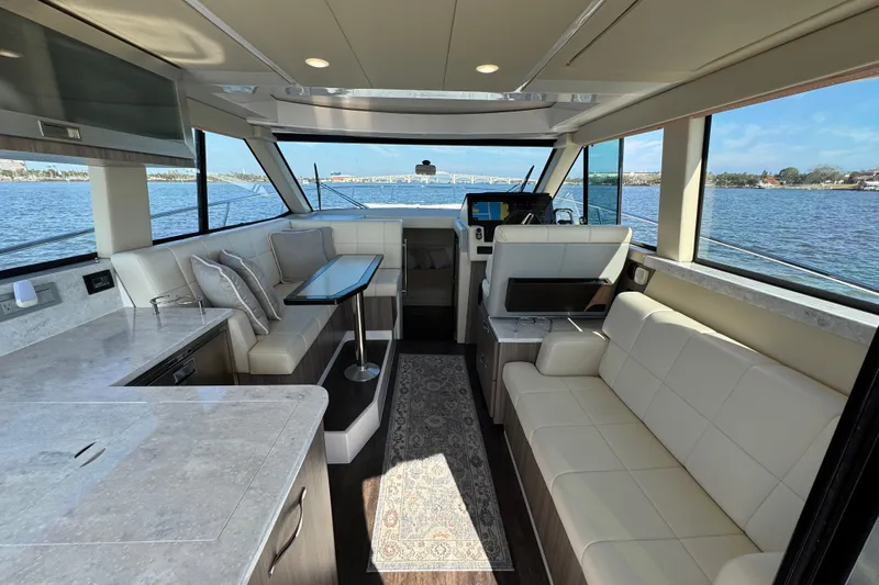 Irresistible Yacht Photos Pics Luxurious interior of 2021 Regal 38 XO yacht with elegant seating and scenic water views.