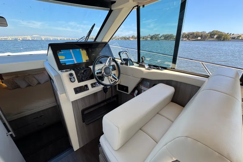 Irresistible Yacht Photos Pics 2021 Regal 38 XO yacht interior with modern helm and navigation system.