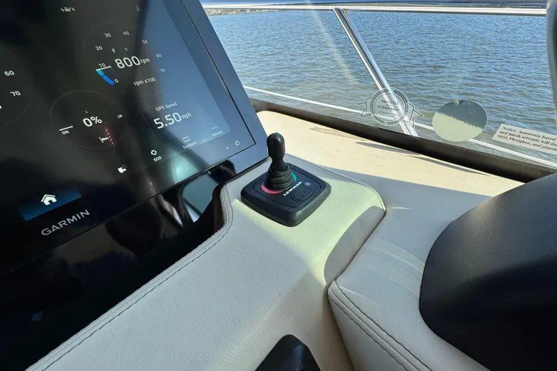 Irresistible Yacht Photos Pics 2021 Regal 38 XO boat dashboard with Garmin display and joystick control.
